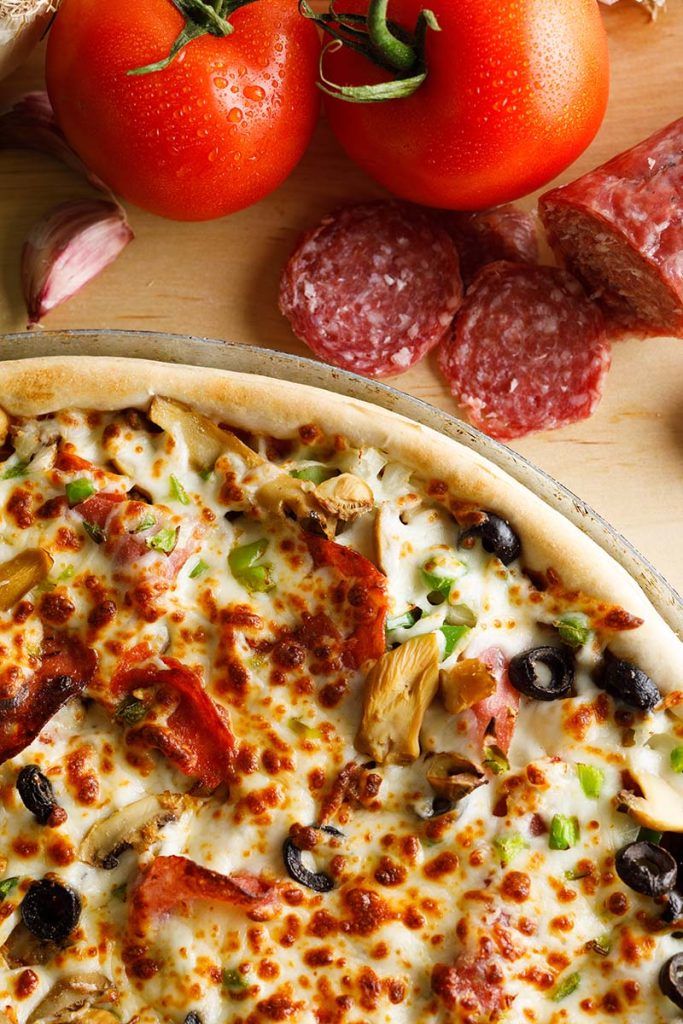 Mobster Pizza Staged with Fresh Vegetables and Ingredients